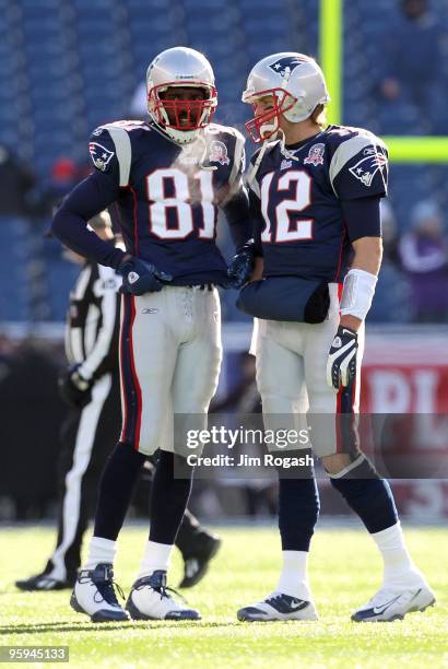 Randy Moss and Tom Brady of the New England Patriots talk on the field during warm ups against the Baltimore Ravens during the 2010 AFC wild-card...