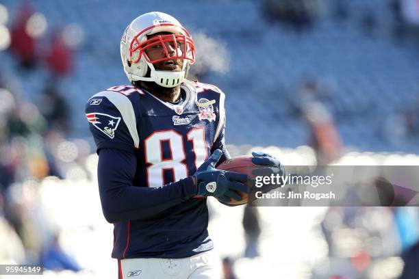 Randy Moss of the New England Patriots looks on during warm ups against the Baltimore Ravens during the 2010 AFC wild-card playoff game at Gillette...