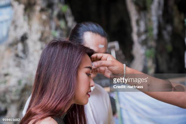 young couple visiting the batu caves near kuala lumpur - batu caves stock pictures, royalty-free photos & images