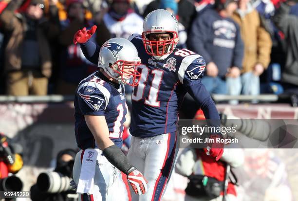 Julian Edleman and Randy Moss of the New England Patriots celebrate after Edleman scored his first touchdown of the game against the Baltimore Ravens...