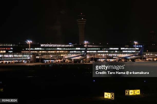 tokyo haneda international airport in tokyo in japan night time aerial view from airplane - tokyo international airport ストックフォトと画像