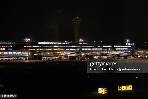 tokyo haneda international airport in tokyo in japan night time aerial view from airplane - tokyo international airport stock pictures, royalty-free photos & images