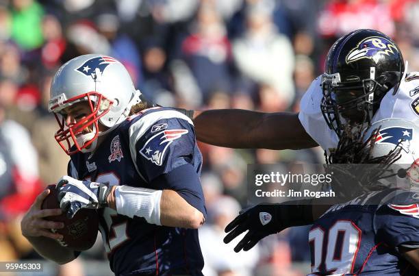 Tom Brady of the New England Patriots attempts to break the grasp of Ray Lewis of the Baltimore Ravens during the 2010 AFC wild-card playoff game at...