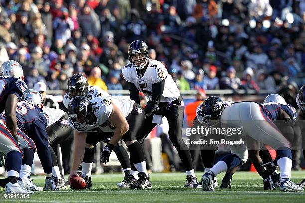 Quarterback Joe Flacco of the Baltimore Ravens calls out signals at the line of scrimmage as he stands under center Matt Birk of the New England...