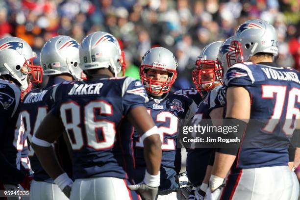 Tom Brady of the New England Patriots looks on from the huddle against the Baltimore Ravens during the 2010 AFC wild-card playoff game at Gillette...