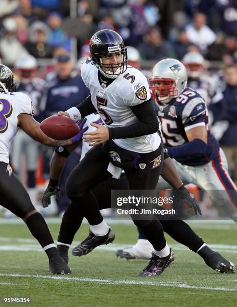 Quarterback Joe Flacco of the Baltimore Ravens turns to hand the ball off against the New England Patriots during the 2010 AFC wild-card playoff game...