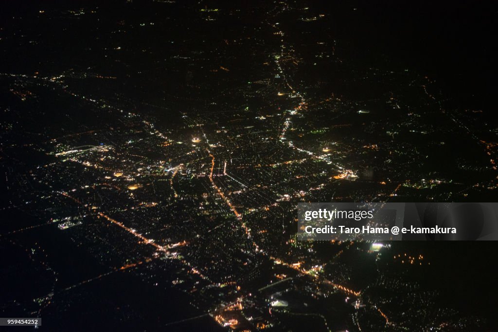 Center of Takaoka city in Toyama prefecture in Japan night time aerial view from airplane
