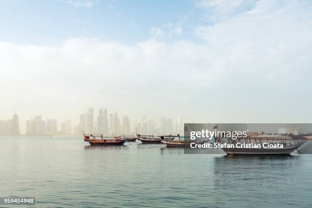 boats in dhow harbour doha, qatar - dhow stock pictures, royalty-free photos & images