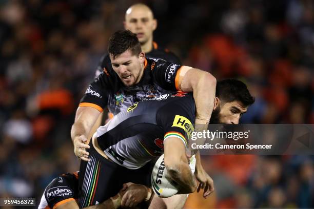 James Tamou of the Panthers is tackled during the round 11 NRL match between the Penrith Panthers and the Wests Tigers at Panthers Stadium on May 17,...