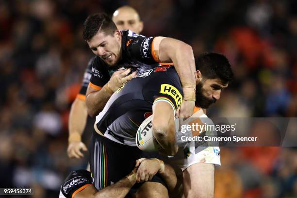 James Tamou of the Panthers is tackled during the round 11 NRL match between the Penrith Panthers and the Wests Tigers at Panthers Stadium on May 17,...