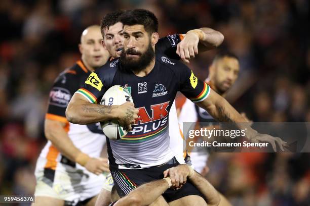 James Tamou of the Panthers is tackled during the round 11 NRL match between the Penrith Panthers and the Wests Tigers at Panthers Stadium on May 17,...