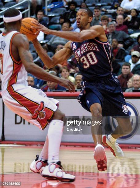 New Jersey Nets Kerry Kittles drives past Atlanta Hawks Jason Terry during the first half of their game at Philips Arena in Atlanta, Georgia 12,...