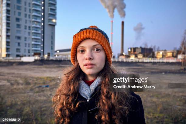 girl standing near apartment block and power station smoke stacks, oulu, finland - smoking girl 個照片及圖片檔