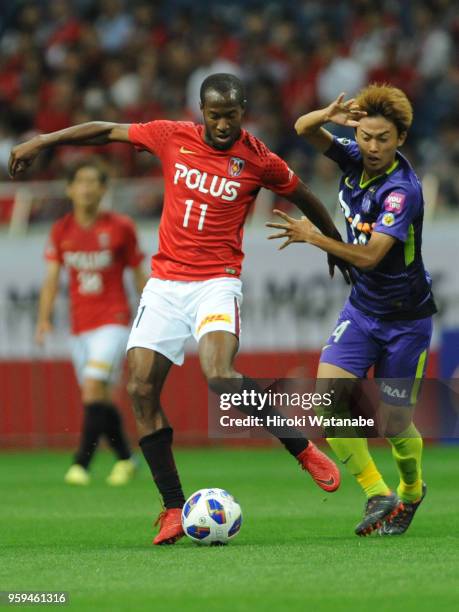 Martinus of Urawa Red Diamonds and Tsukasa Morishima of Sanfrecce Hiroshima compete for the ball during the J.League Levain Cup Group C match between...