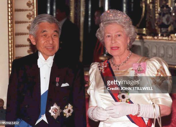 Britain's Queen Elizabeth II accompanies Japanese Emperor Akihito to the State Banquet Hall at Buckingham Palace late 26 May. The Japanese Emperor is...