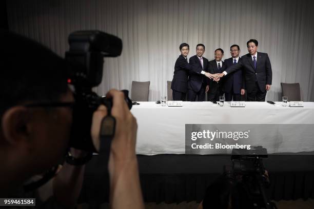 From left to right, Seiichi Nagatsuka, president and vice chairman of Japan Automobile Manufacturers Association Inc. , Hiroto Saikawa, president and...