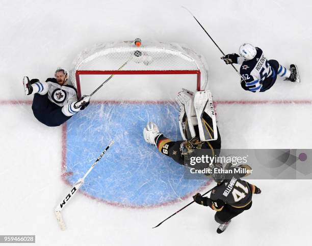 Bryan Little of the Winnipeg Jets slides into a goal post after taking a shot against Marc-Andre Fleury of the Vegas Golden Knights in the second...