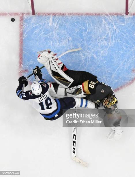 Bryan Little of the Winnipeg Jets slides into Marc-Andre Fleury of the Vegas Golden Knights after taking a shot in the second period of Game Three of...