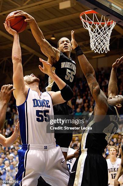 Tony Woods of the Wake Forest Demon Deacons blocks the shot by Brian Zoubek of the Duke Blue Devils during their game on January 17, 2010 in Durham,...