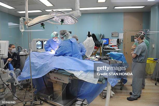 Doctors operate on a Hatian earthquake victim aboard the USNS Comfort hospital ship on 22 January, 2010 in the harbor off Port-au-Prince, Haiti. The...