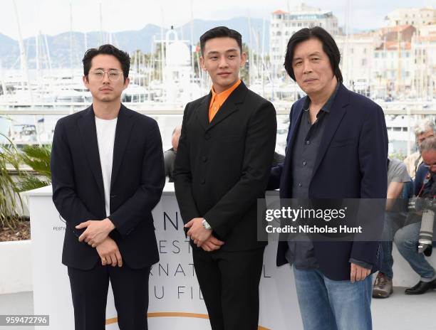 Steven Yeun, Ah-in Yoo and director Chang-dong Lee attend the "Burning" Photocall during the 71st annual Cannes Film Festival at Palais des Festivals...