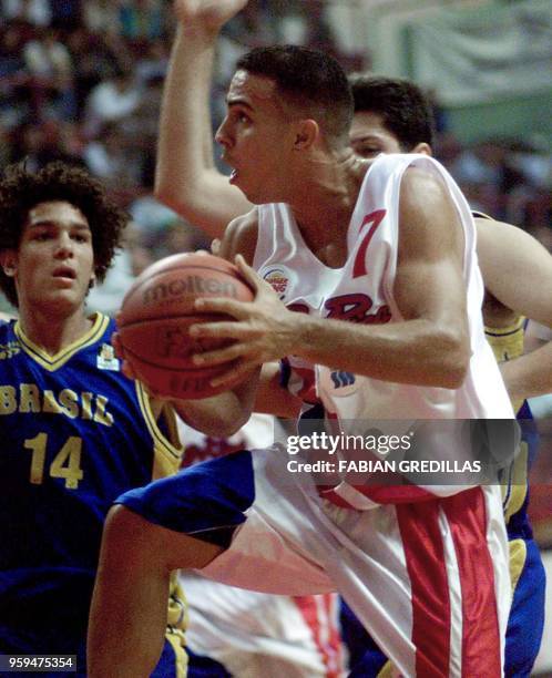 Carlos Arroyo of Puerto Ricao shoots the ball while Anderson of Brazil watches during a second round game of the Pre-World Basketball Tournament of...