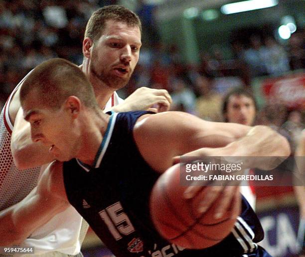 Ruben Wolkowinski of Argentina tries to get around Canada's Todd MacCulloch during a second-round game of the Pre-World Basketball Tournament of the...