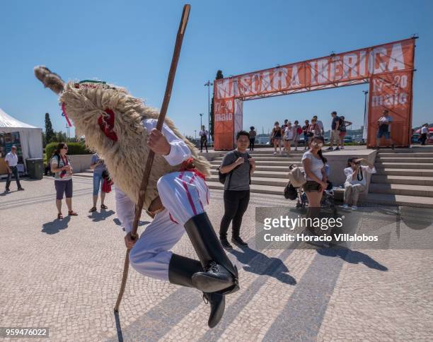 Member of "Los Sidros", Asturias, Spain, jumps aided by a stick during a performance for visitors at Jardim da Praca do Imperio during the XIII...