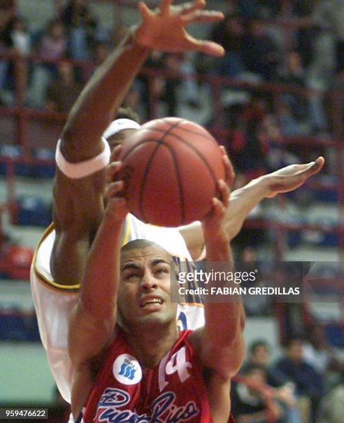 Puerto Rican Raymond Dalmau shoots the ball while being guarded by Jaja Richard of the Virgin Islands during a game in the Ruca-Che Stadium in...