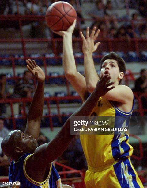 Guillherme of Brazil tries to block a shot by Andy Chelecher of the Virgin Islands during a second-round game of the Pre-World Basketball Tournament...