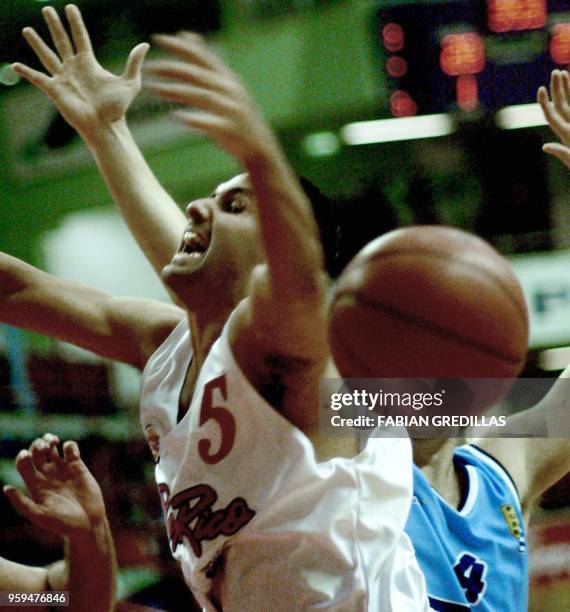 Edin Santiago of Puerto Rico loses the ball while being guarded by Juliano Rivero of Uruguay during a game in the Ruca-Che Stadium in Neuquen,...