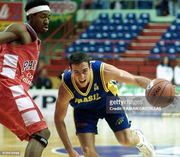 Demetrius of Brazil dribbles the ball past Michael Hicks of Panama during a second round of the Pre-World Basketball Tournament in the Ruca-Che...