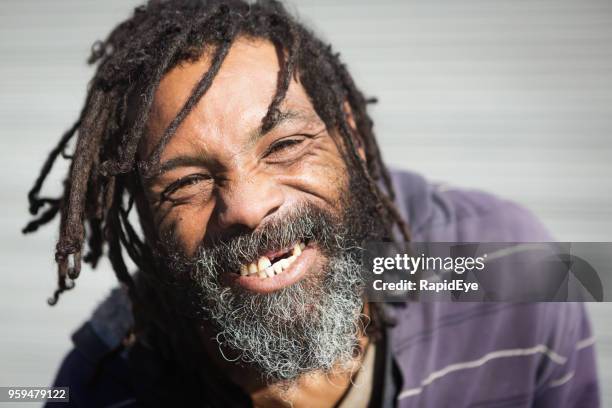 rastafarian with missing teeth laughs - homeless man stock pictures, royalty-free photos & images