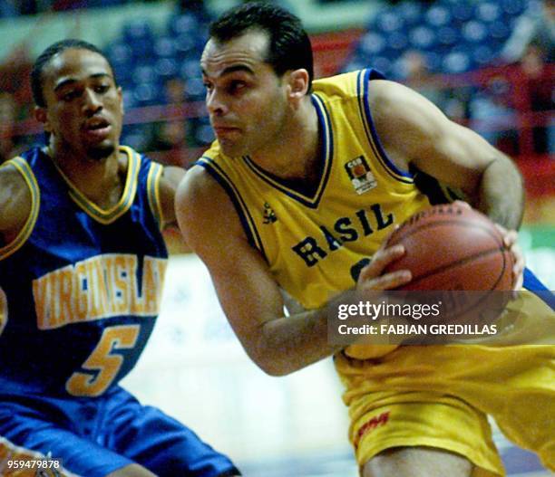 Vanderlei of Brazil triest to evade Marcus Oliver of the Virgin Islands during a second-round game of the Pre-World Basketball Tournament in te...