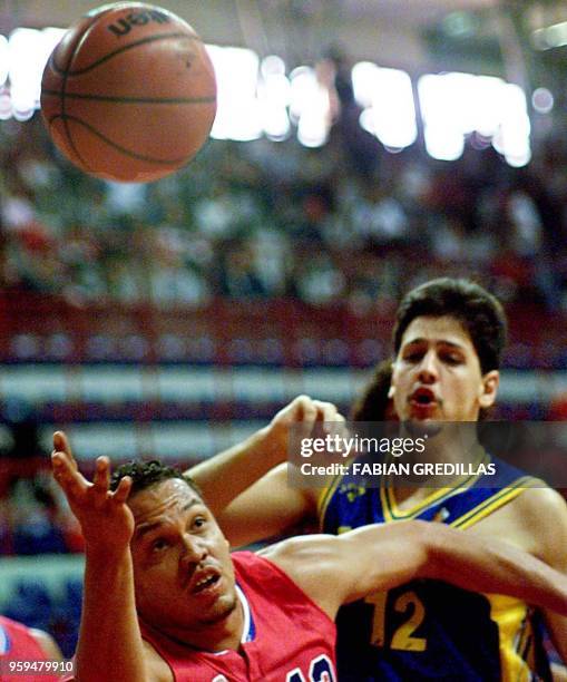 Antonio Garcia of Panama tries to grab the ball while Guillerme of Brazil watches during a second round game of the Pre-World Basketball Tournament...