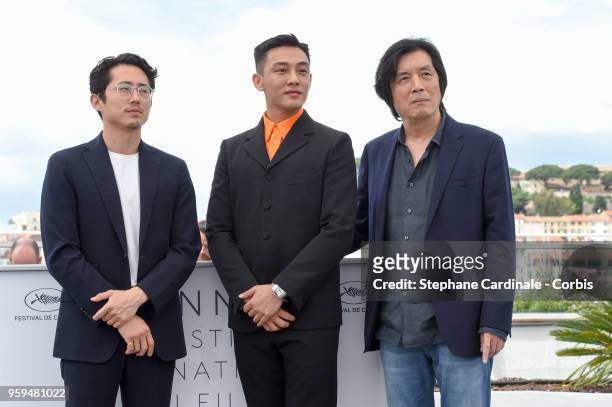 Steven Yeun, Ah-in Yoo and director Chang-dong Lee attend "Burning" Photocall during the 71st annual Cannes Film Festival at Palais des Festivals on...