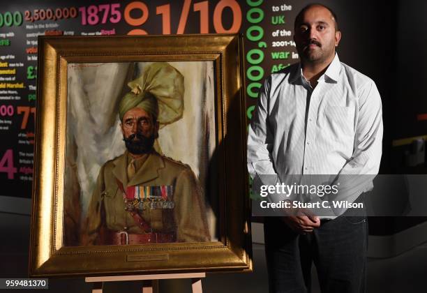 Ali Nawaz Chaudhary stands next to an official portrait of his Grandfather, Khudadad Khan VC, the First Indian Recipient of the Victoria Cross at The...