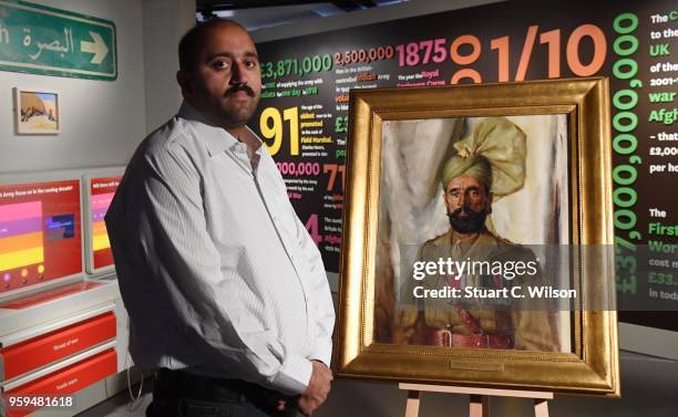 Ali Nawaz Chaudhary stands next to an official portrait of his Grandfather, Khudadad Khan VC, the First Indian Recipient of the Victoria Cross at The...