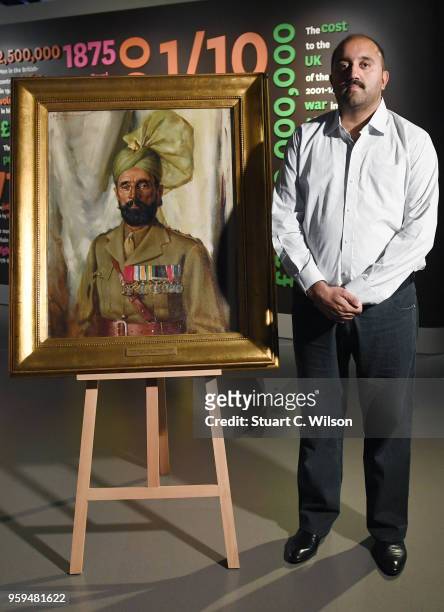 Ali Nawaz Chaudhary stands next to an official portrait of his Grandfather, Khudadad Khan VC, the First Indian Recipient of the Victoria Cross at The...