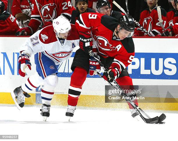 Zach Parise of the New Jersey Devils controls the puck while being defended by Brian Gionta of the Montreal Canadiens during their game at the...