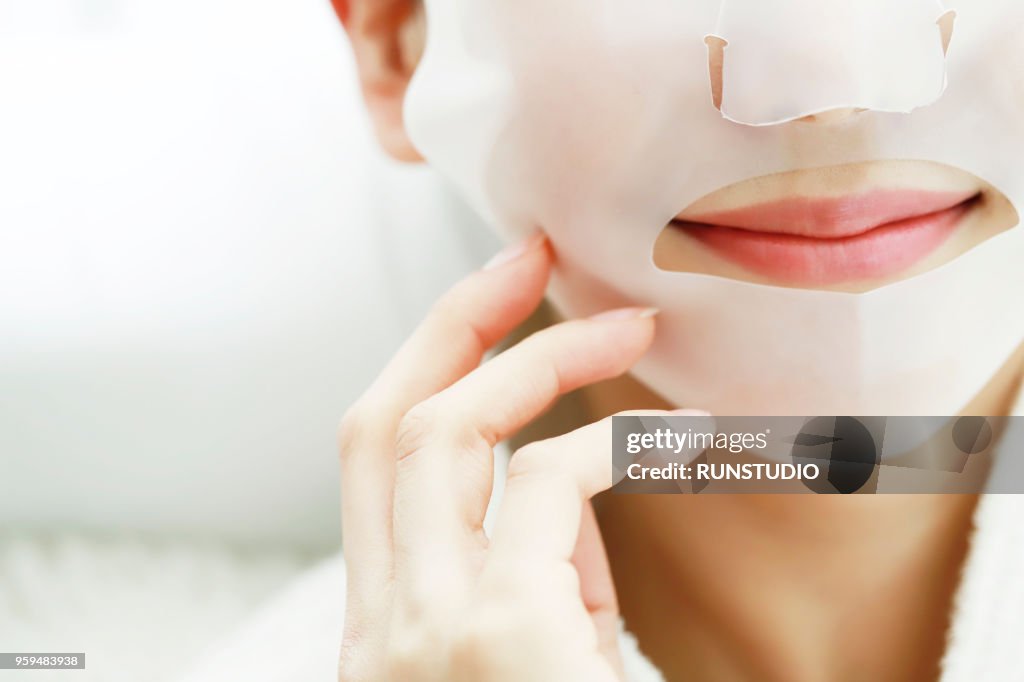 Close-Up Of Woman Applying Facial Mask