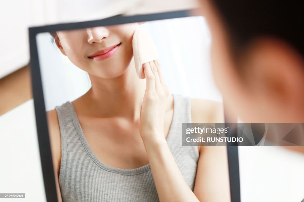 Woman applying face powder