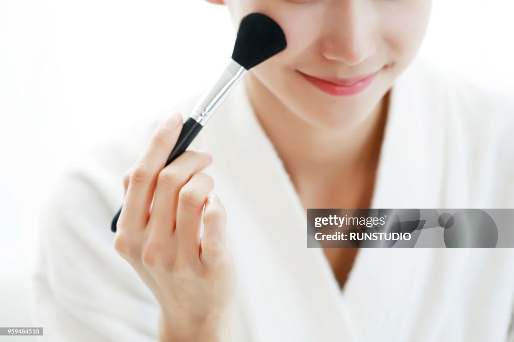 Woman applying blush