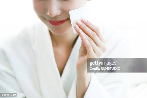 woman cleaning face with cotton pad - woman applying cotton ball stock pictures, royalty-free photos & images