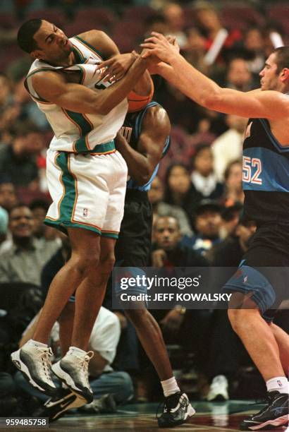 Detroit Pistons player Grant Hill gets the ball batted away from him by Cleveland Cavaliers Vitali Potapenko in a exhibition game at the Palace of...