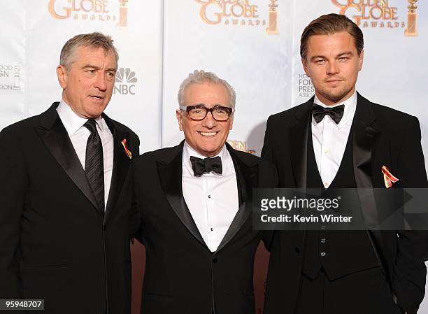 Director Martin Scorsese, recipient of the Cecil B. DeMille Award poses with actors Robert De Niro and Leonardo DiCaprio in the press room after...