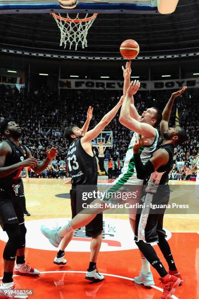 Kyrylo Fesenko of Sidigas competes with Jamil Wilson and Klaudio Ndoja and Marcus Slaughter of Segafredo during the LBA LegaBasket match between...