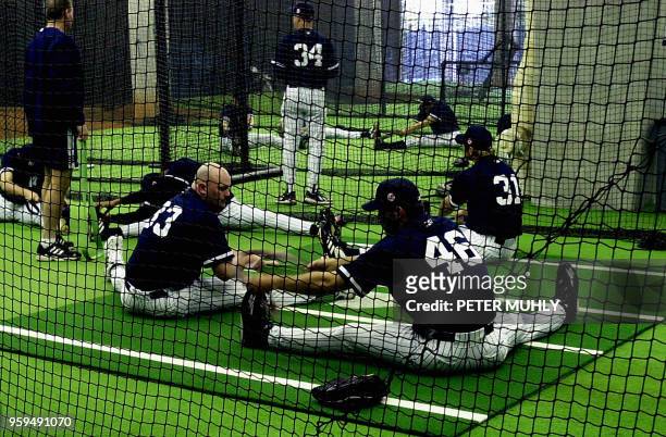 New York Yankees players David Wells , Andy Pettitte and Steve Karsay warm up indoors 22 February 2002 during a brief spring training workout at...