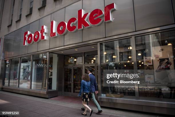 Pedestrians pass in front of a Foot Locker Inc. Store in downtown Chicago, Illinois, U.S., on Sunday, May 13, 2018. Foot Locker Inc. Is scheduled to...