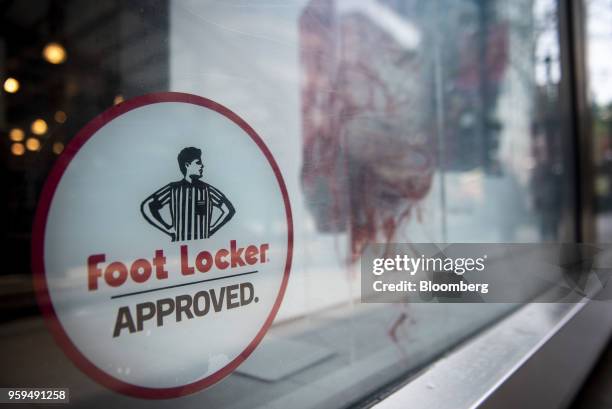 Foot Locker Inc. Signage is displayed on the window of a store in downtown Chicago, Illinois, U.S., on Sunday, May 13, 2018. Foot Locker Inc. Is...